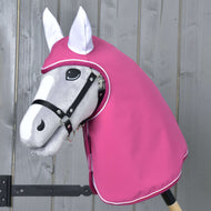 Pláštěnka LarDen od Hobby Horse LarDen na šedé hračce Hobby Horse s černou uzdečkou a růžovou kapucí pro ochranu před nepříznivým počasím, zobrazená před dřevěnou stěnou.
